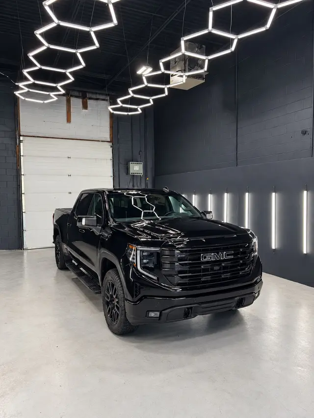 Black GMC Sierra photographed in The Auto Edit studio after two-year System X Crystal ceramic coating