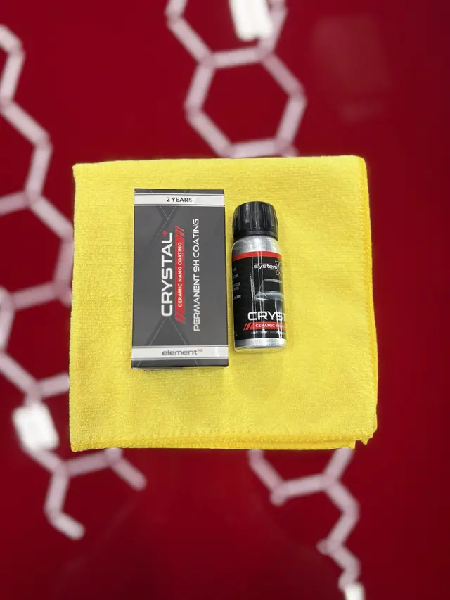 Two-year System X Crystal ceramic coating product photographed on the Tesla's red paint